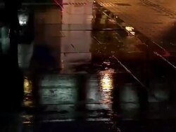 MS Shot of Rainy street light reflections on paved street / Tokyo, Japan Stock Footage