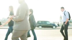 Side view of commuters walking past the camera Stock Footage