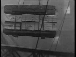 B/W 1933 tilt down pallet of crates being lowered on rope from large ship / end of Prohibition Stock Footage