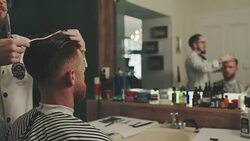 Barber cutting a mans hair Stock Footage