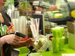 MS PAN wrap sandwich in plastic container handed to cashier at retail counter as cashier girl is about to process transaction Stock Footage