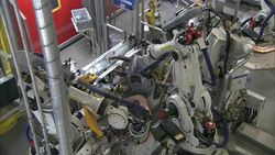 Robots weld and assemble parts in an automotive factory. Stock Footage