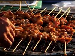 Food Preparation: Turning Skewers on Charcoal Grill Stock Footage