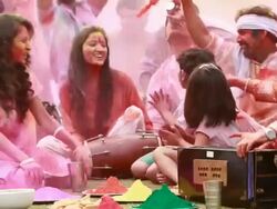 Family celebrating holi festival in the lawn  Stock Footage