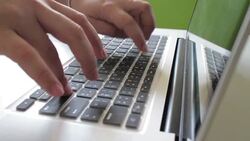 Hand typing a laptop computer Stock Footage