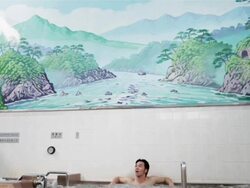 WS, TD A man sits in a traditional Japanese public bath house or sento / Tokyo, Japan Stock Footage