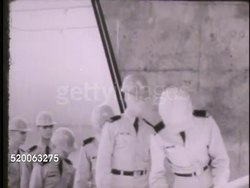 1963: UNITED STATES AIR FORCE ACADEMY: VS First year cadets walking by bus during field trip, studying large mechanical piece (could be part of tank). INT VS Cadets in classroom, sitting at table. Colorado, CO, Rampart Range, Summer course Instructional Video