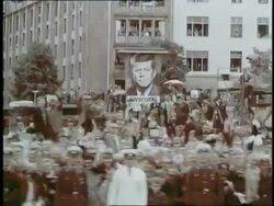 Huge crowds in Berlin, West Germany, cheer and wave enthusiastically at President John F. Kennedy riding in a motorcade. News Clip