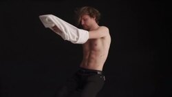 Young man rotates on swivel chair Stock Footage