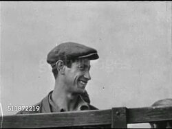1945: PALESTINE: REFUGEE SHIP: Man walking down ship gangplank handing baby to nurse, VS People on board & leaving ship. People walking up harbor w/ British soldier overseeing.  Refugees, Displace Persons, limited immigration, WWII Survivors. Instructional Video
