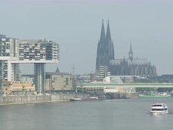WS Cologne Cathedral with the three Cranehouses and Boat moving on river / Cologne, North Rhine-Westphalia, Germany Stock Footage