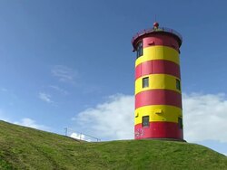 MS Sky moving over Pilsum Lighthouse near Krummhorn at North Sea (Eastern Friesland) / Lower Saxony Stock Footage