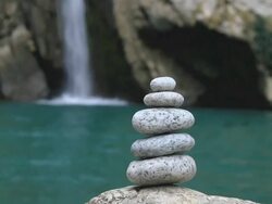 Balanced stones on waterfall background Stock Footage