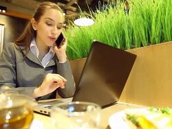 HD:Businesswoman working by using mobile phone at restaurant. Stock Footage