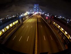 Night time, time lapse, wide angle of Philadelphia cityscape, overhead shot traffic crosses the Ben Franklin Bridge. Stock Footage