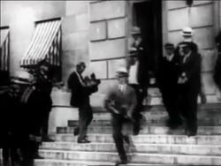 B/W 1933 group of men walking down stairs / one carries Tommy gun / Machine Gun Kelly in cuffs Stock Footage