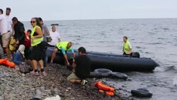 Syrian migrants fleeing the war and escaping to Europe, landing on the Greek island of Lesvos on the north coast at Efthalou. Up to 4,000 migrants a day are landing on the island and overwhelming the authorities. They are traficked by illegal Turkish peopl Stock Footage
