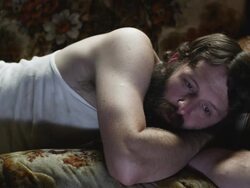 MS PAN Man lying on sofa, watching television, Orem, Utah, USA Stock Footage