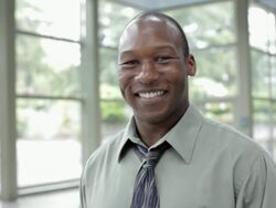Smiling Black businessman crossing arms Stock Footage
