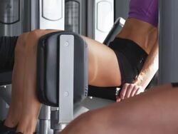 woman working out on exercise machines at the gym Stock Footage