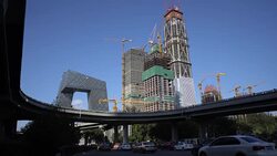 Overpass and traffic under the skyscraper project of China Zun in Beijing CBD Stock Footage