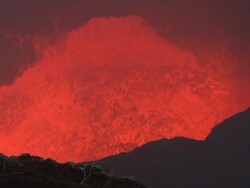 Molten lava flows in crater as rock falls in, Marum Volcano, Ambrym Island, Vanuatu Stock Footage