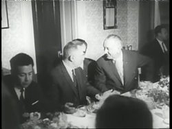 In 1967 President Lyndon B. Johnson and Soviet Premier Alexei Kosygin talk with an interpreter at a dinner table. News Clip