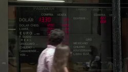 CLEAN : Argentine peso closes at 14 per US dollar as controls lifted News Clip