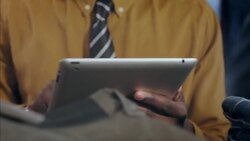 Modern shop worker uses tablet to take stock of clothing store Stock Footage