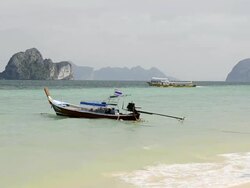 WS View of Long tail boat in Surf and Limestone rock in Sea, Marine National Park / Ko Hai, Krabi, Thailand Stock Footage