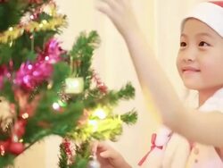 Portrait of happy girl decorating Christmas tree Stock Footage
