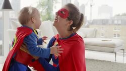 Superhero mother and daughter playing in living room Stock Footage