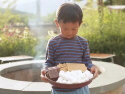  MS Child standing in front of fire pit holding tray with marshmallows, graham crackers, and chocolate / Stowe, Vermont Stock Footage