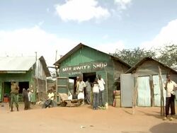 Truck passes through village Stock Footage