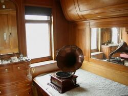 A gramophone on a bedside table in a room of a wagon train Stock Footage