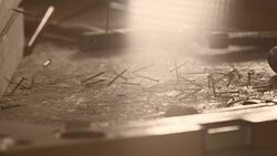 Slow motion shot of nails falling on a table in workshop Stock Footage