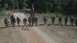 Confederate soldiers march past a dead soldier who lies on the road. Stock Footage