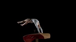 SLO MO DS Female gymnast performing back handspring on vault Stock Footage