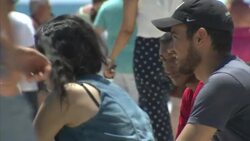 Tourists Posing For Photographs Next To Flower Memorial News Clip