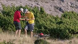 Two UAV pilots preparing the controllers before drone takes off Stock Footage