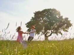 SLO MO Mother and daughter spinning in meadow Stock Footage