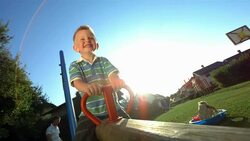 HD Super Slow-Mo: Little Boy Playing On A Seesaw Stock Footage