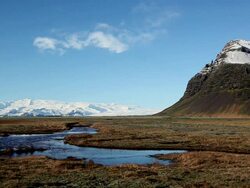 WS View of Wind makes ripples on small lagoon in front of snow covered mountain / Iceland  Stock Footage