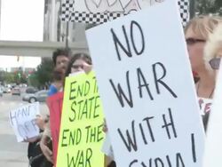 Protesters with No War With Syria protest signs. Stock Footage