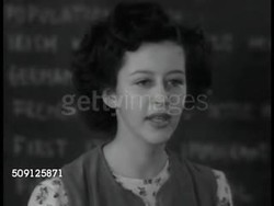 1944: AMERICANISM: INT High School class, girl talking about being free from persecution, aunt was killed in Germany because Jewish, students listening. Bulletin board posting 'Town Meeting' WS Meeting. Students at table, 'equal justice, opportunity' Instructional Video
