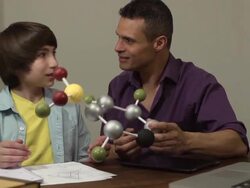 Son Shows Father his Science Project of a Molecule Stock Footage