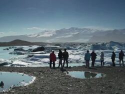 Tourist looking floting iceberg Jokulsarlon lagoon Stock Footage