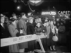 B/W 1955 crowd of onlookers behind police line at premiere of "The Benny Goodman Story" / newsreel Stock Footage
