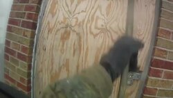 Slow Motion firefighters force open door and window of burning hime Stock Footage