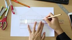 Female drawing house in office Stock Footage